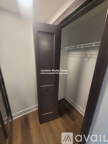 A wooden door in a room with a mirror on the wall.