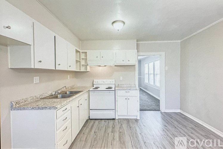 A kitchen with white appliances and cabinets.