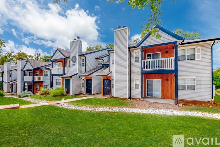 A row of houses with a grassy front yard.