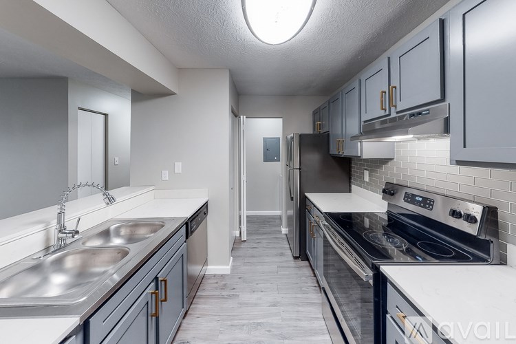 A kitchen with a stove, sink, and oven.