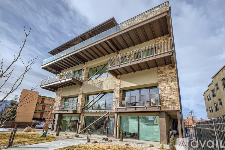 A modern two-story building with a balcony on the upper floor.
