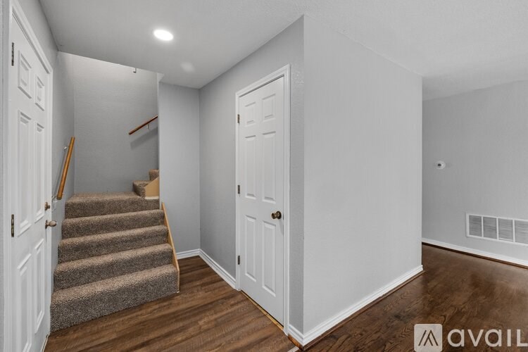 A room with a staircase and a door.