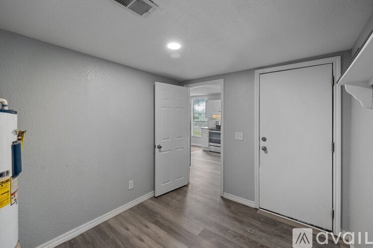 A room with a white door and a white wall.