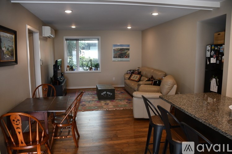 A living room with a brown table and chairs.