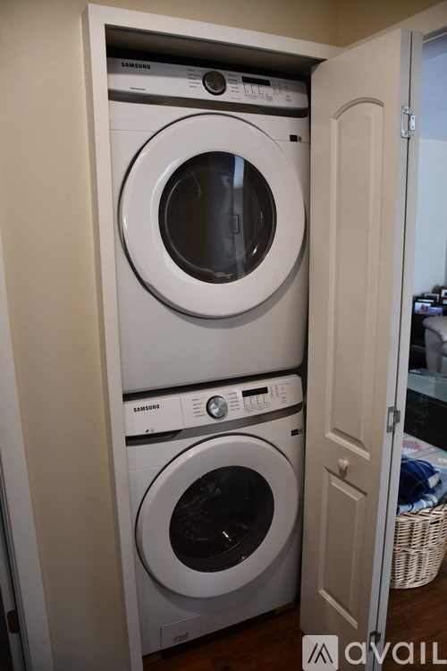 A white Samsung dryer and washer in a small laundry room.