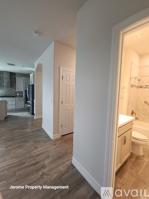 A bathroom with a toilet, sink, and a shower stall.