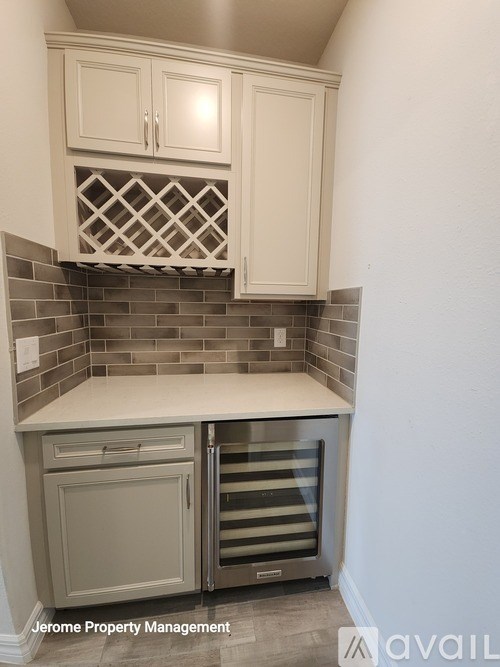 A kitchen with white cabinets and a tile backsplash.