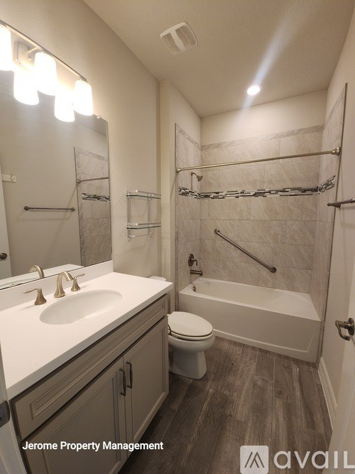 A bathroom with a toilet, sink, and bathtub.