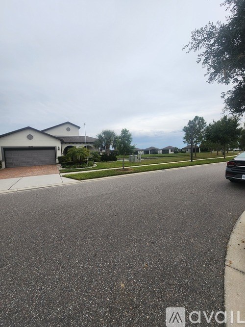A car is parked on the right side of a street.