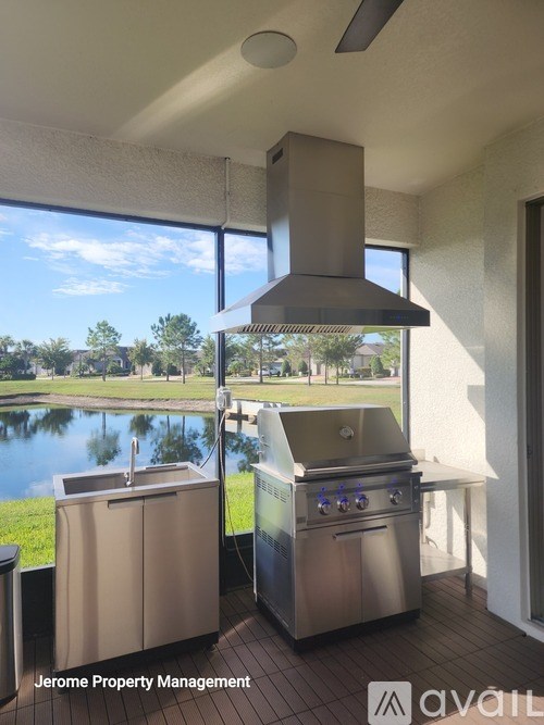 A modern outdoor kitchen with a grill and sink.