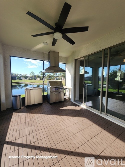 A patio with a ceiling fan and sliding glass doors.