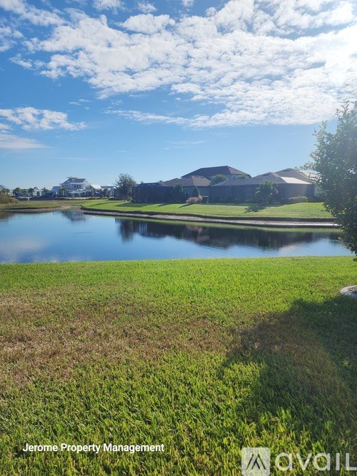 A serene landscape with a body of water and buildings in the distance.