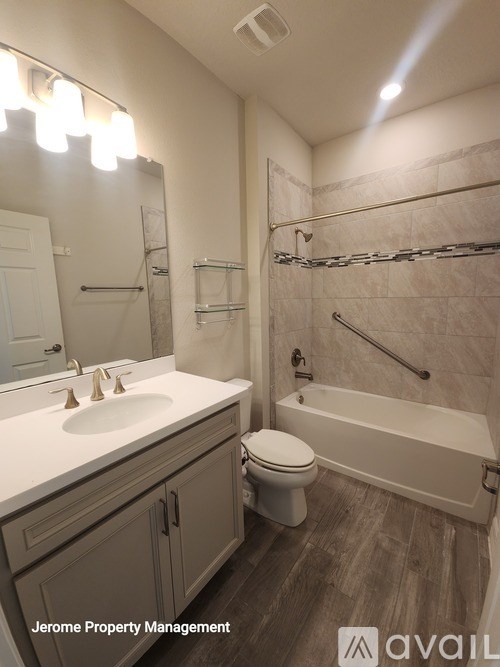 A bathroom with a sink, toilet, and bathtub.