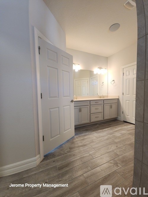A bathroom with a vanity and a mirror.