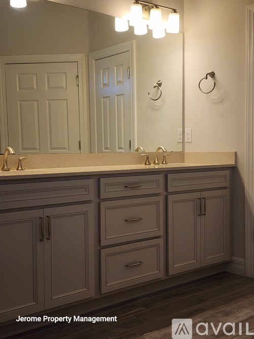 A bathroom vanity with a mirror and lights above it.