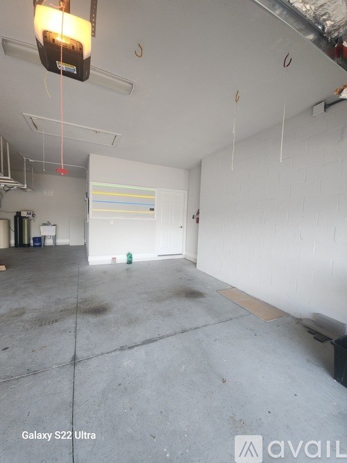 A room with a white wall and a door in the middle.