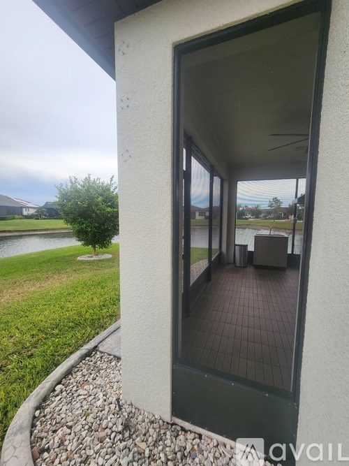 A patio with a table and chairs is visible through a glass door.