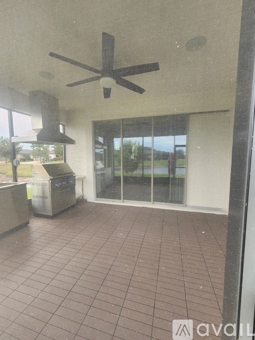 A room with a ceiling fan and tiled floor.