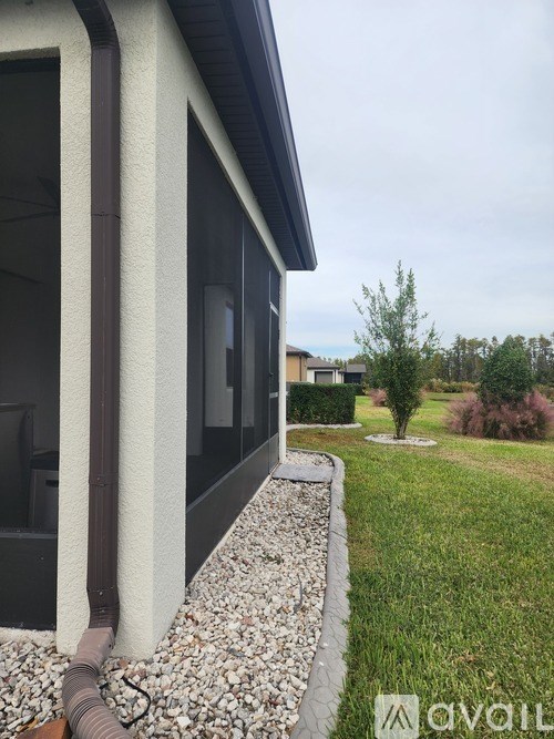 A house with a brown gutter on the side.