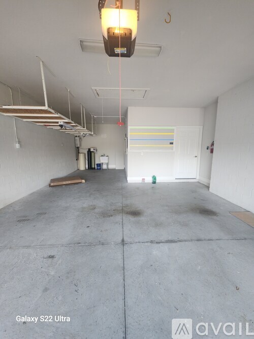 A room with a Galaxy S22 Ultra hanging from the ceiling.