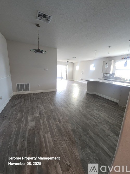 A room with wooden flooring and a ceiling fan.