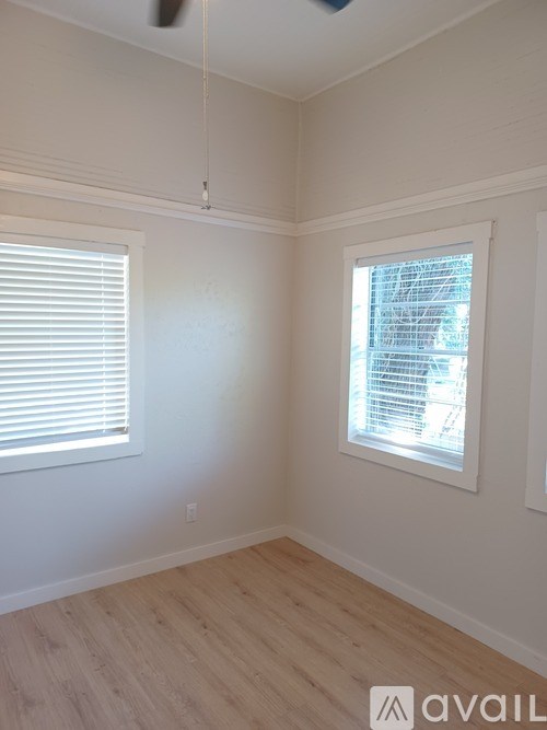 A room with a window and a ceiling fan.