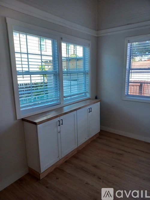 A room with a window and a cabinet.