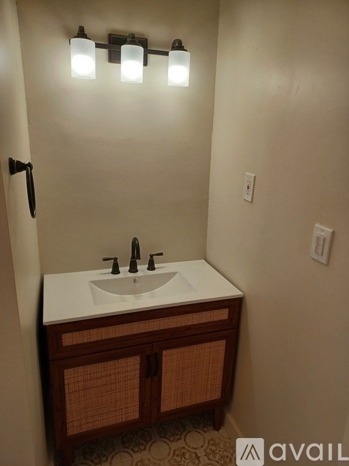 A bathroom with a sink and lights.