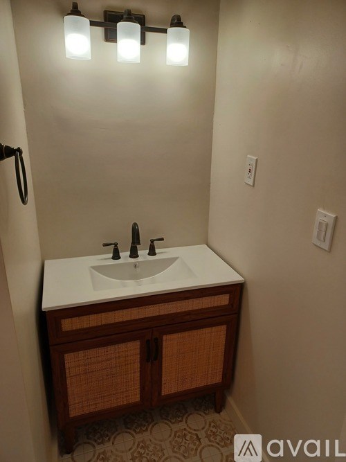 A bathroom with a sink and lights.