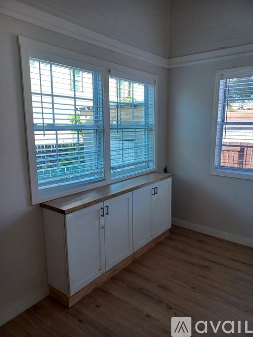 A room with a window and a cabinet.