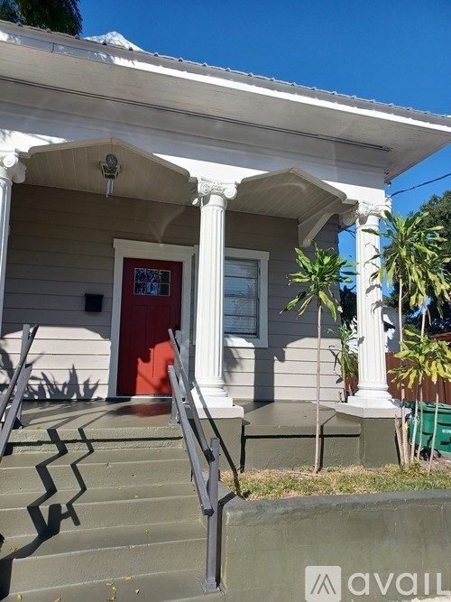 A house with a red door and a white porch.