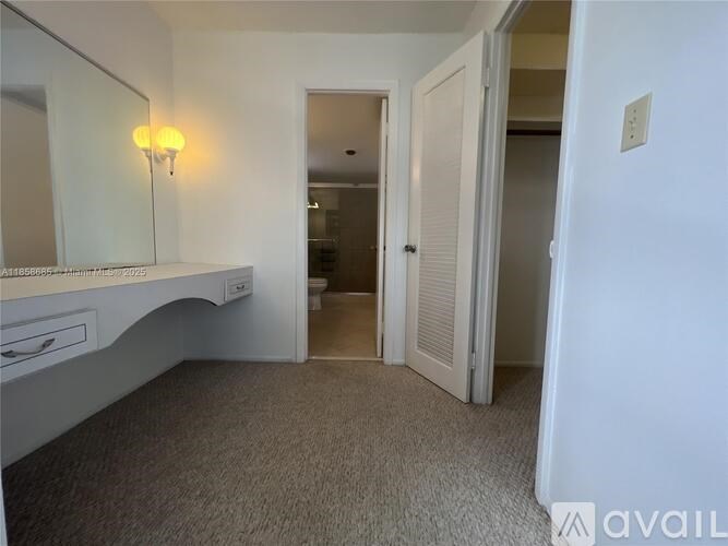 A bedroom with a vanity and a mirror.
