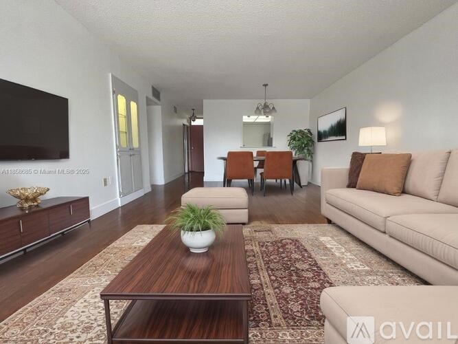 A living room with a brown coffee table and a beige couch.