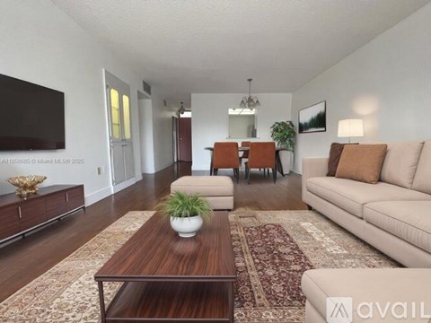 A living room with a brown coffee table and a beige couch.