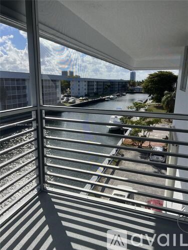 A view from a window looking out at a river and buildings.