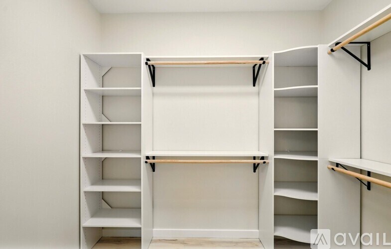 A white closet with shelves and hanging rails.