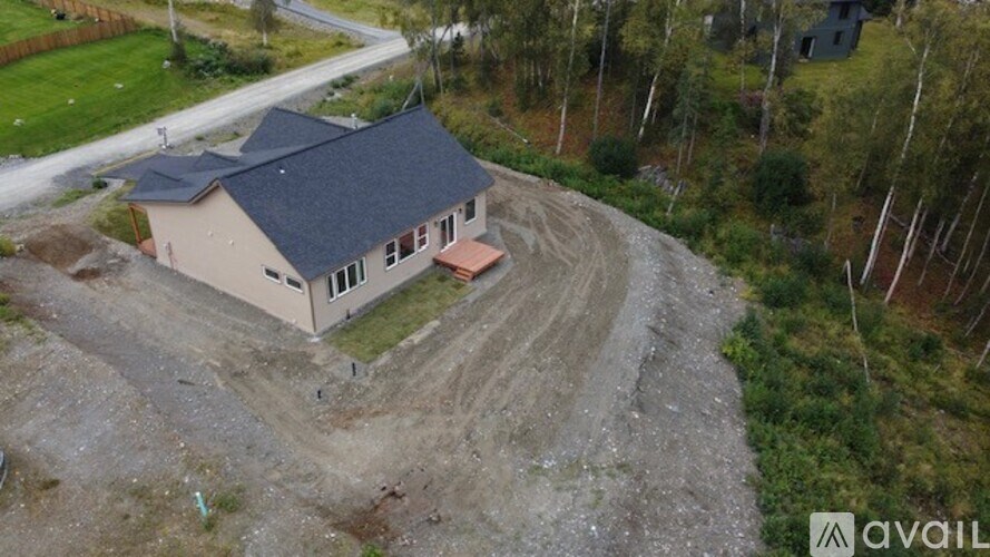 A house under construction with a grey roof and a brown foundation.