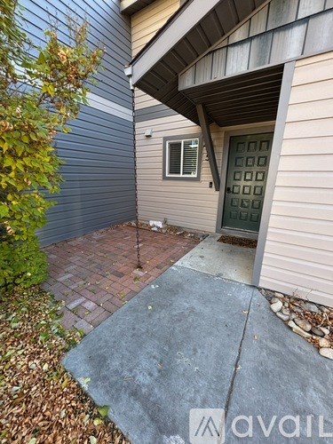 A small patio area with a door and a window.
