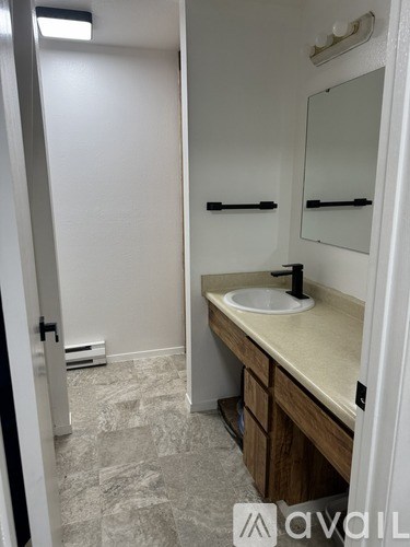 A bathroom with a sink and a mirror.