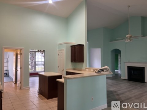 A kitchen with a counter and cabinets is available for rent.