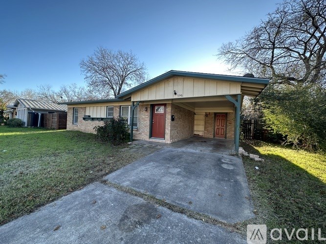 A house with a driveway in front of it is for sale.