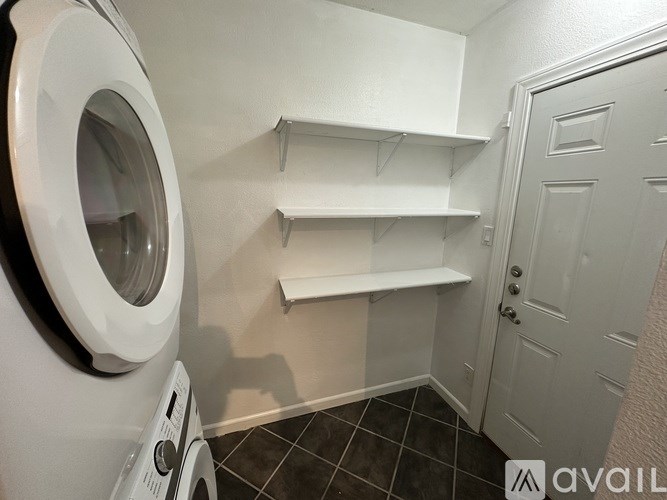 A small laundry room with a washer and dryer.