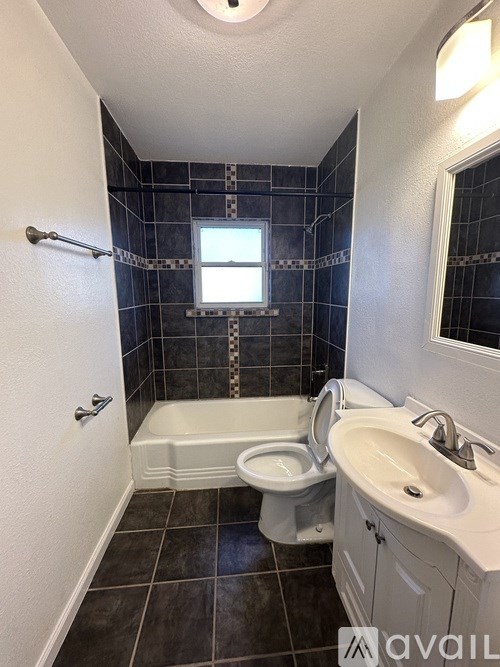 A bathroom with a toilet, sink, and bathtub.