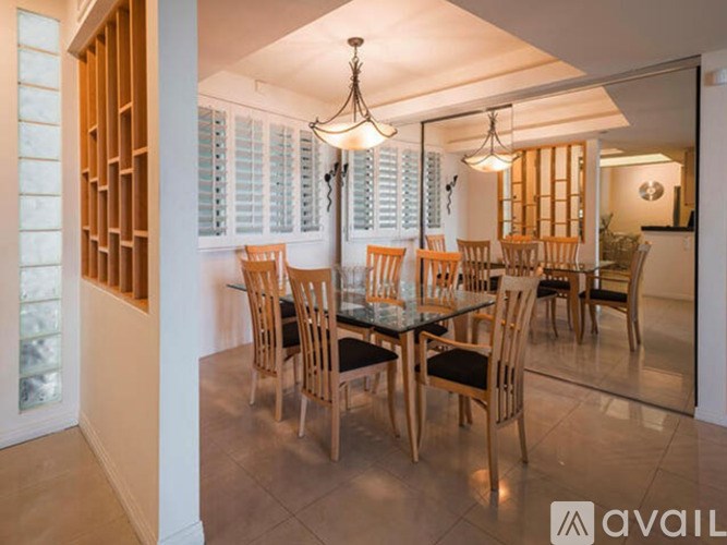 A dining room with a glass table and chairs.