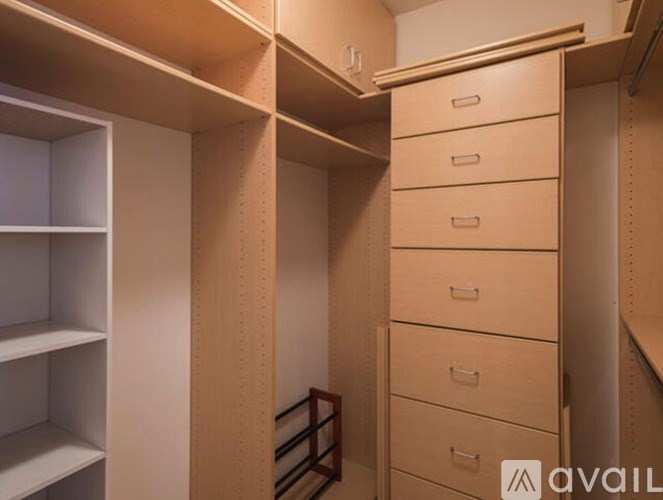 A wooden closet with drawers and shelves.