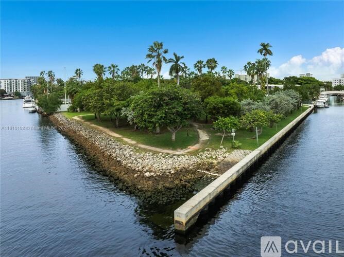 A small island with a dock in the middle of a body of water.