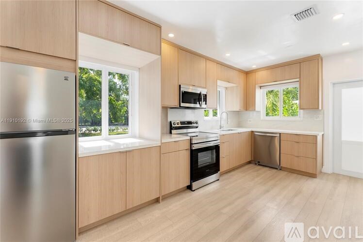 A kitchen with wooden cabinets and stainless steel appliances.