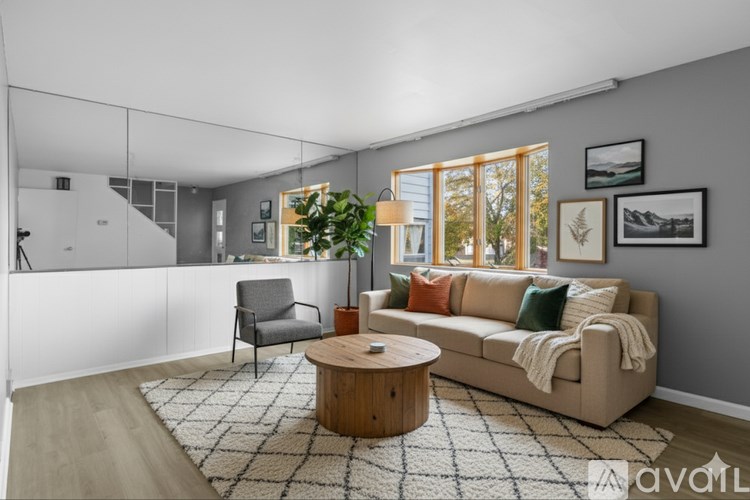 A living room with a couch, chair, and a coffee table.