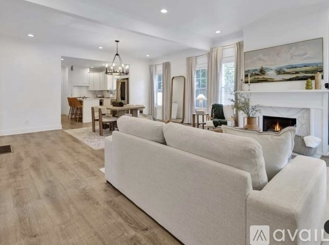 A modern living room with a fireplace and a large couch.
