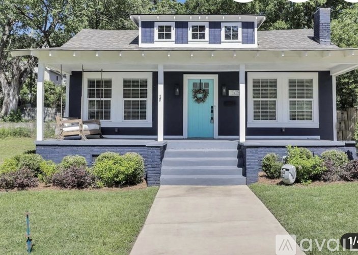 A house with a blue door and a porch.